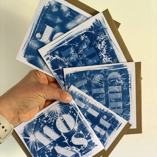 Blue and white cards held on a white backdrop 