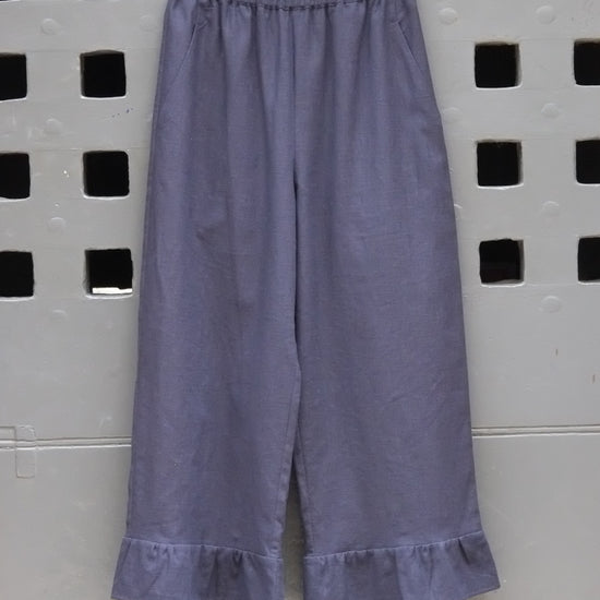 frill trouser navy fabric on a grey door background