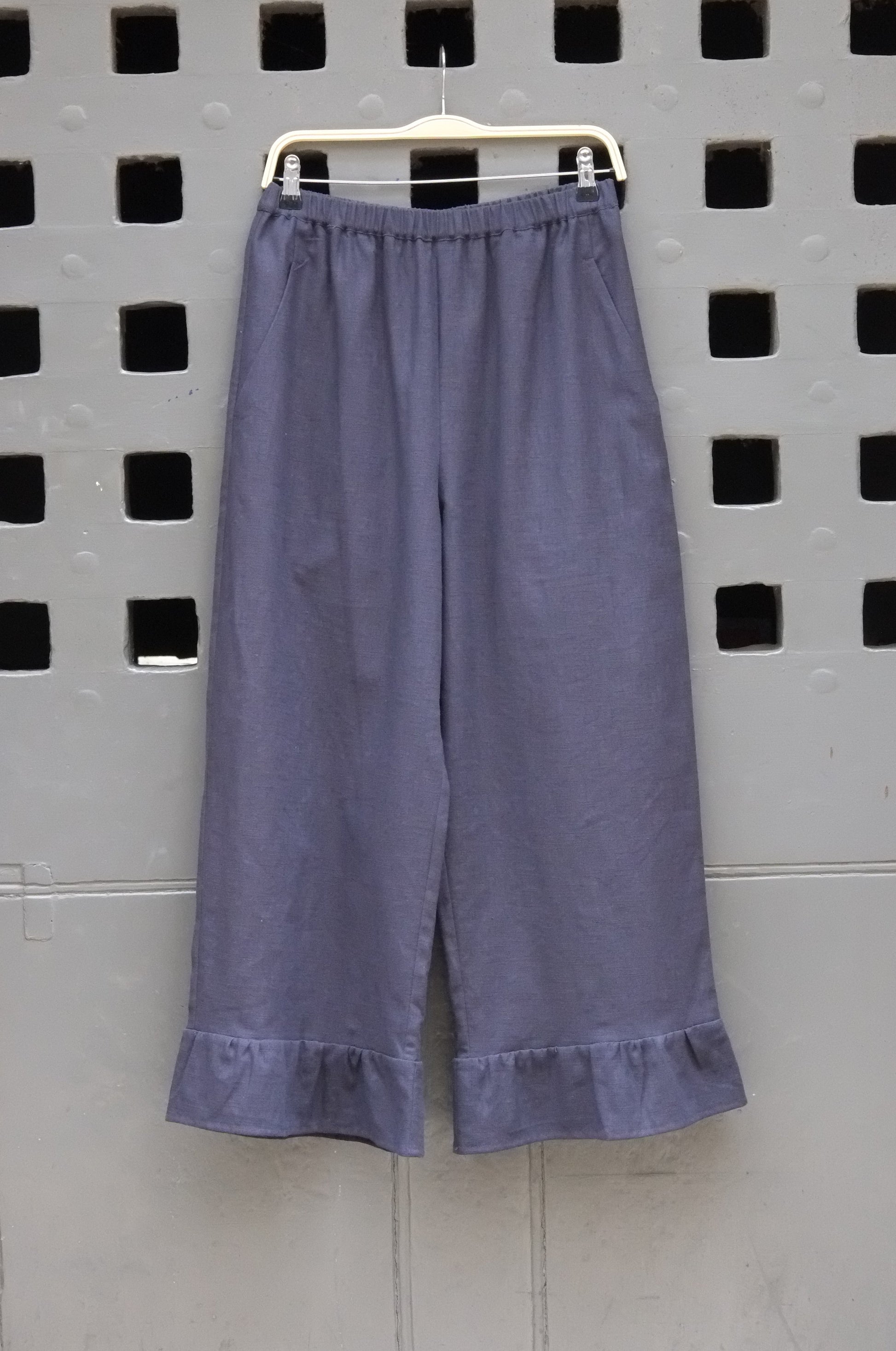 frill trouser navy fabric on a grey door background