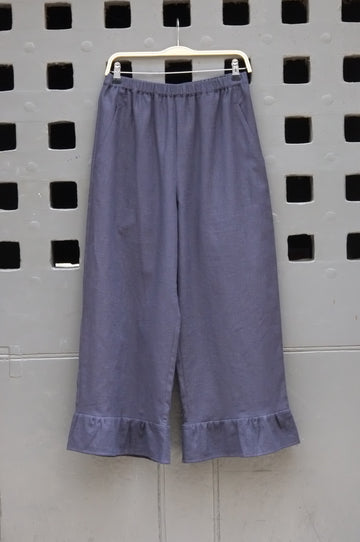 frill trouser navy fabric on a grey door background