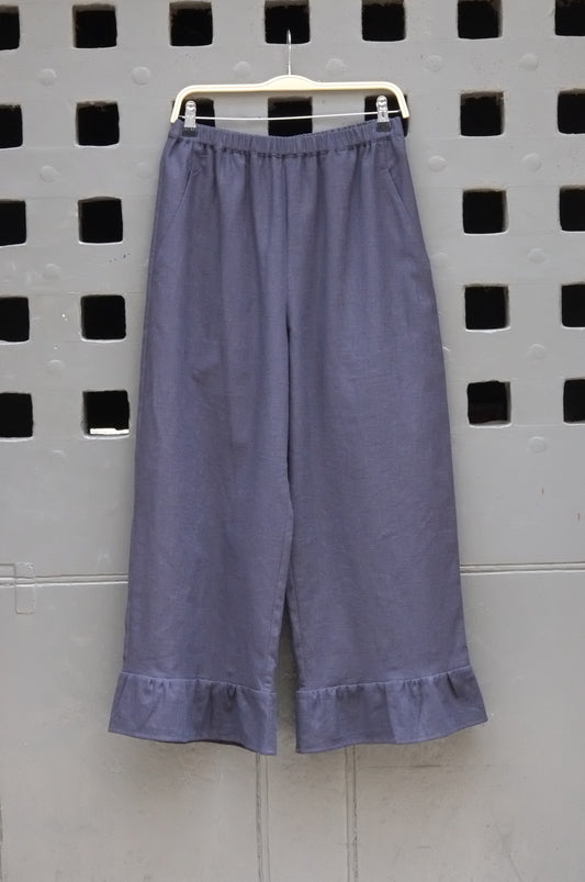 frill trouser navy fabric on a grey door background