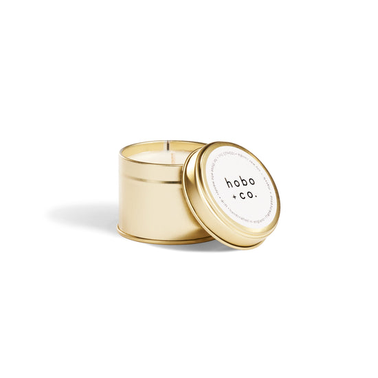 Gold candle tin with 'hobo co.' label on a white background