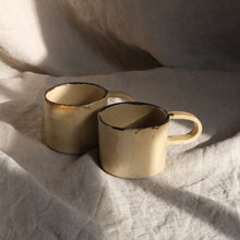 Load image into Gallery viewer, Two ceramic mugs on a textured white fabric surface
