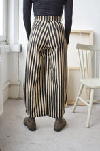 Load image into Gallery viewer, woman wearing long black and white striped trousers facing the wall
