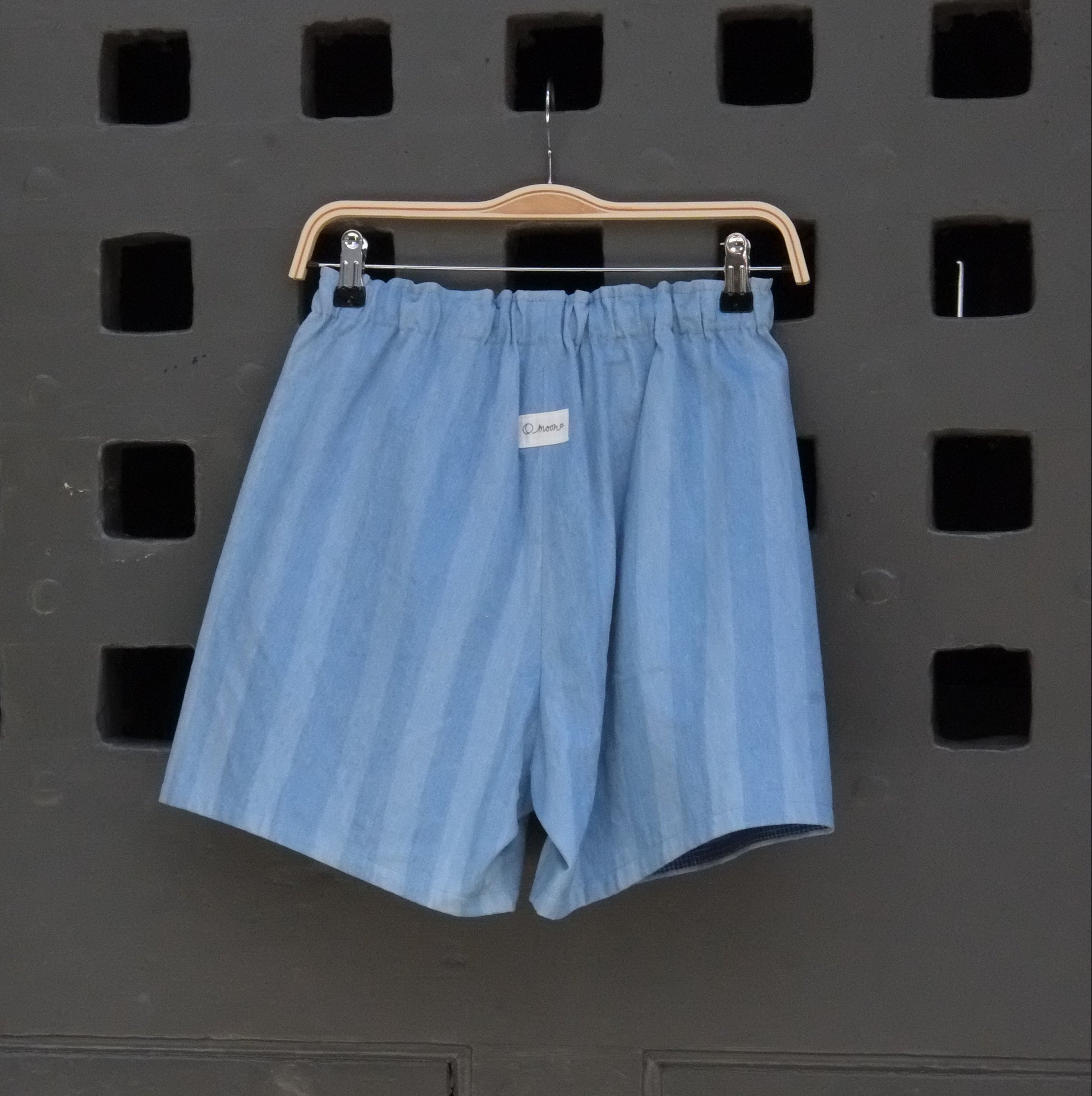 blue striped shorts on a grey door 