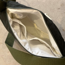 Load image into Gallery viewer, Green bag with open interior showing beige lining on a neutral background
