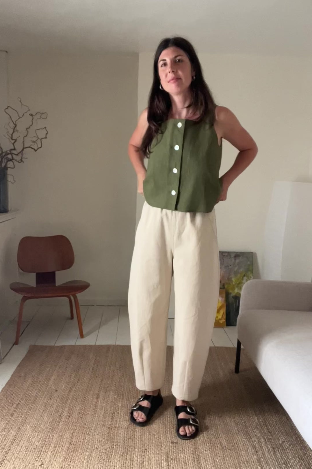 women wearing a handmade khaki linen sleeveless button through top and ecru denim barrel leg trousers