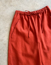 Load image into Gallery viewer, Reddish-brown drawstring linen trousers with drawstring on a light gray background
