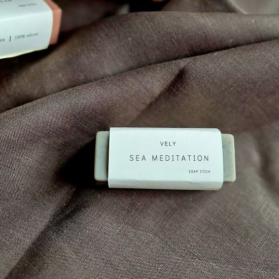 Soap stick labeled 'Vely Sea Meditation' on a textured fabric background