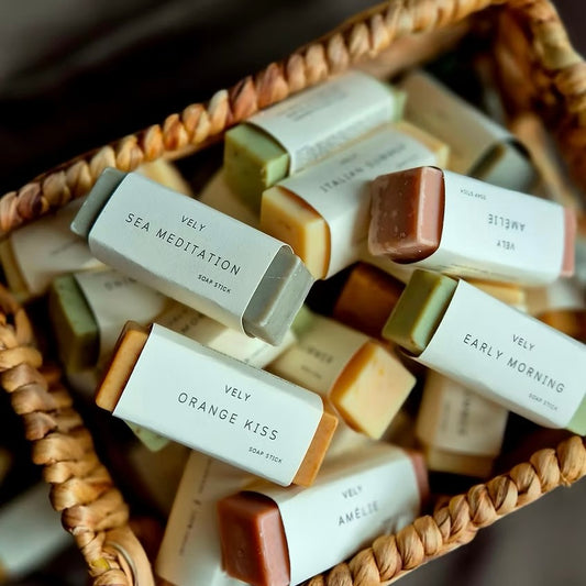 Assorted Vely soap bars in a wicker basket with visible labels.