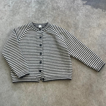 a striped knitted cardigan on a beige background 